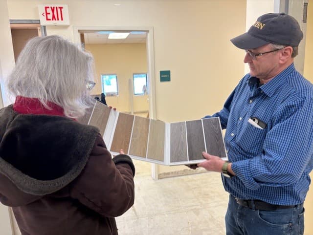 Two people looking at flooring samples